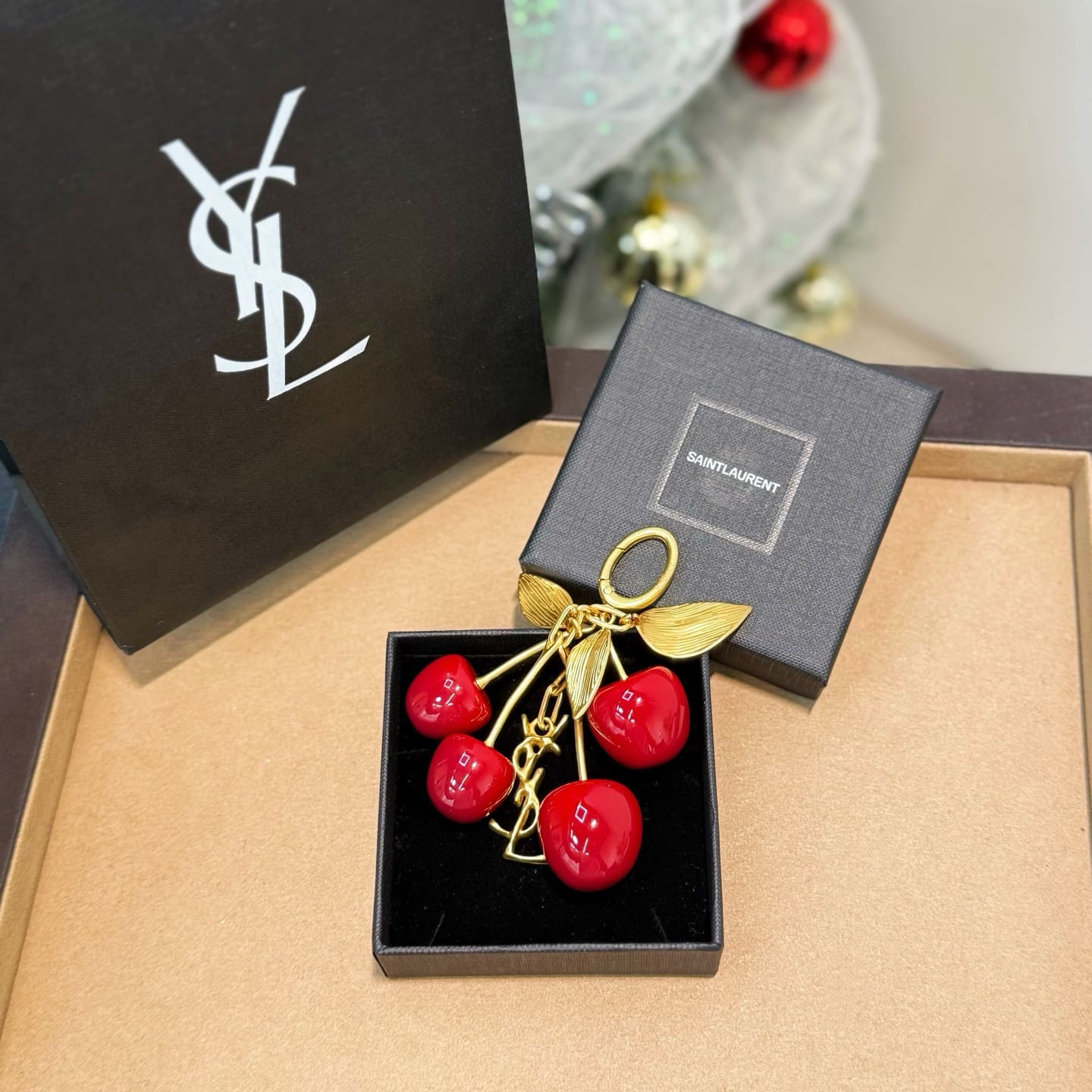 SAINT LAURENT CASSANDRE cherry bag charm in resin and metal