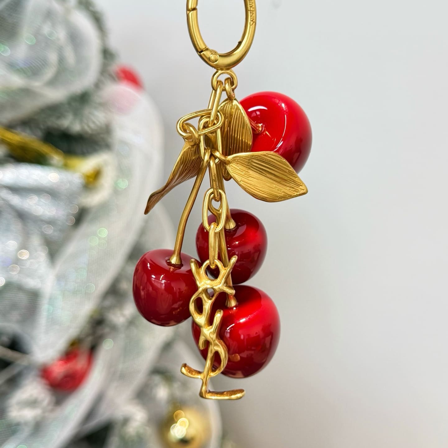 SAINT LAURENT CASSANDRE cherry bag charm in resin and metal