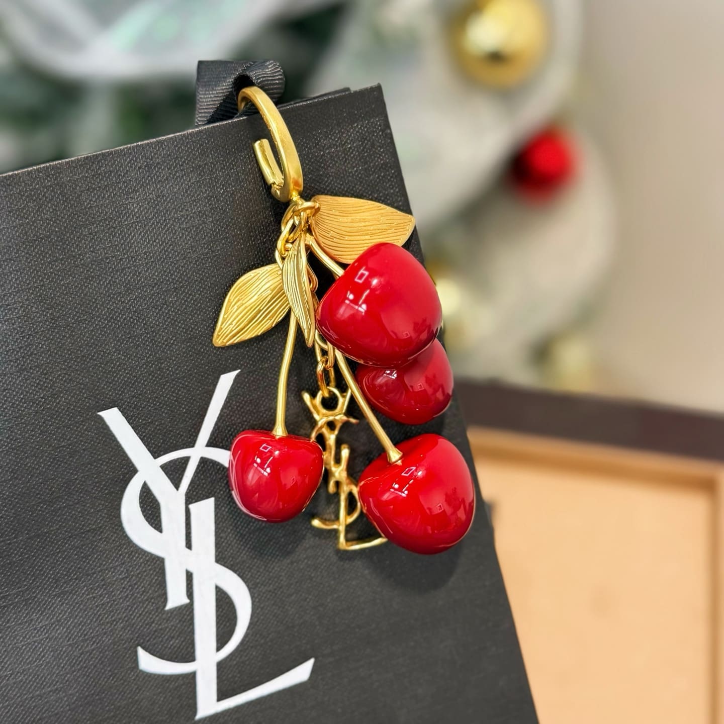 SAINT LAURENT CASSANDRE cherry bag charm in resin and metal