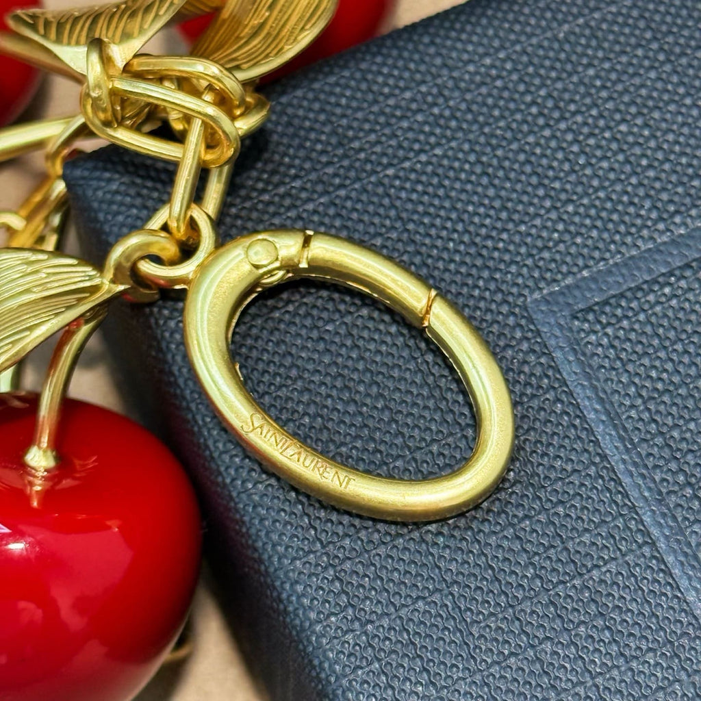 SAINT LAURENT CASSANDRE cherry bag charm in resin and metal