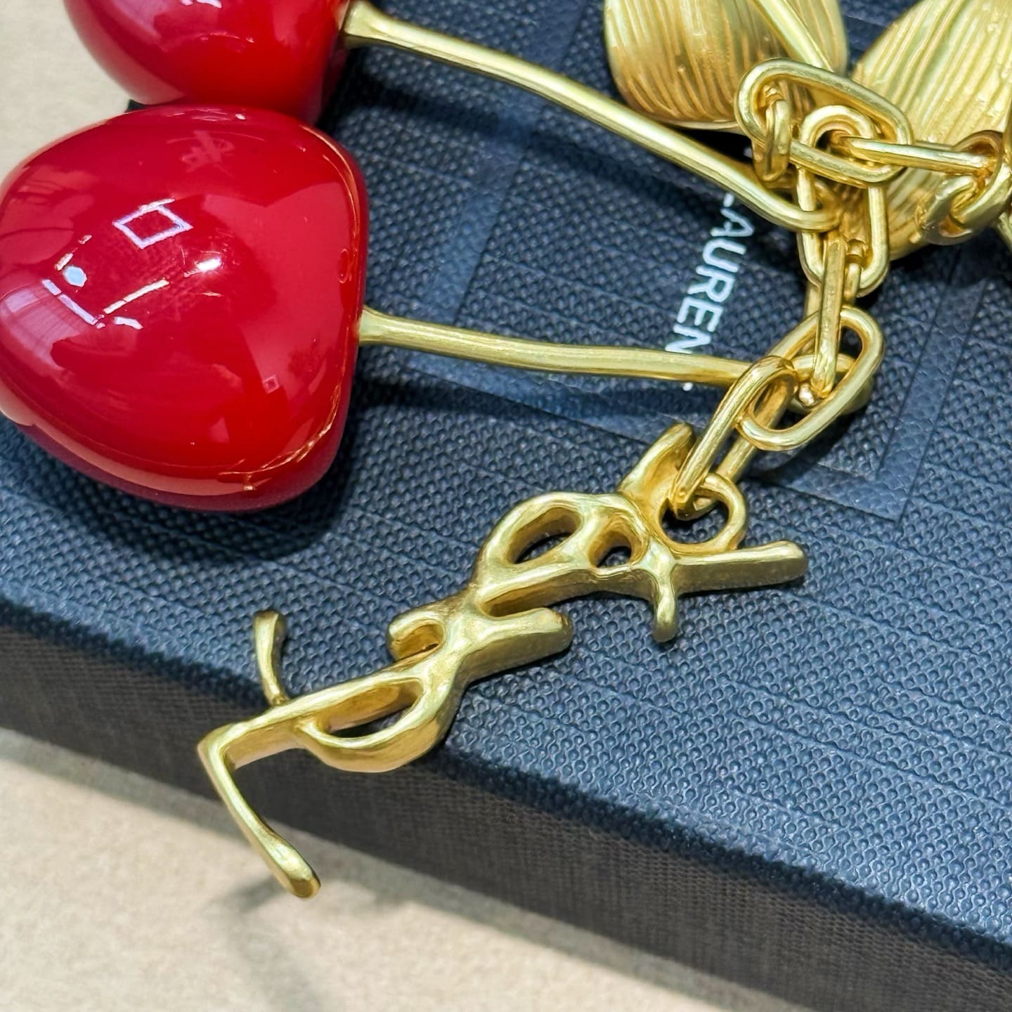 SAINT LAURENT CASSANDRE cherry bag charm in resin and metal